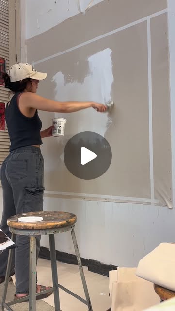 Mia priming a canvas