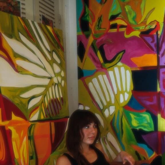 Mia seated with Terrarium paintings